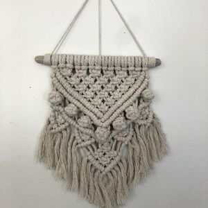 Macramé wall hanging on driftwood stick